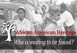 Historic photo of four African-Americans standing around an early model car.