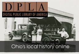 A librarian holding books and standing next to a 1920's bookmobile.