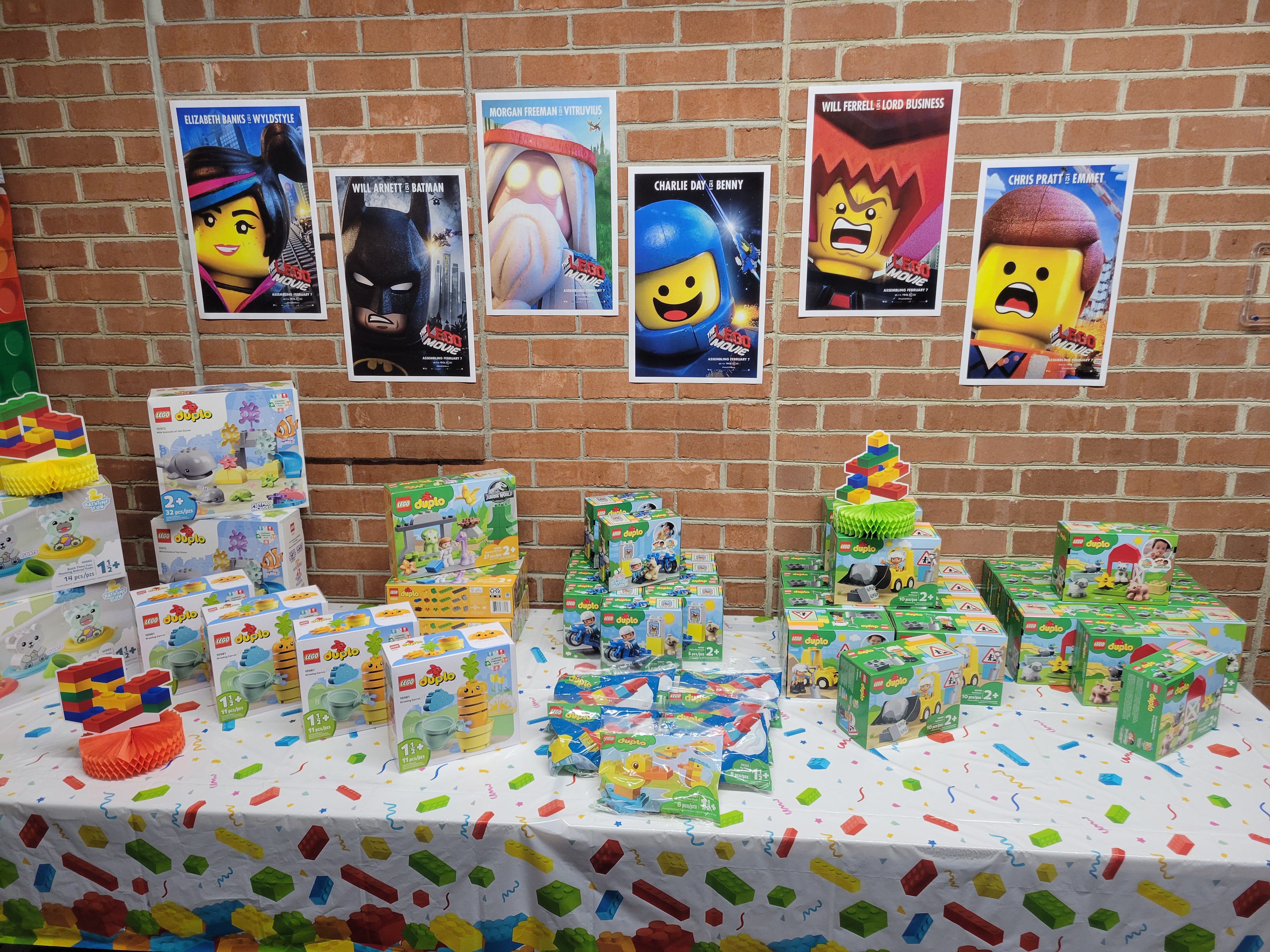 table decorated with duplos and LEGO movie posters