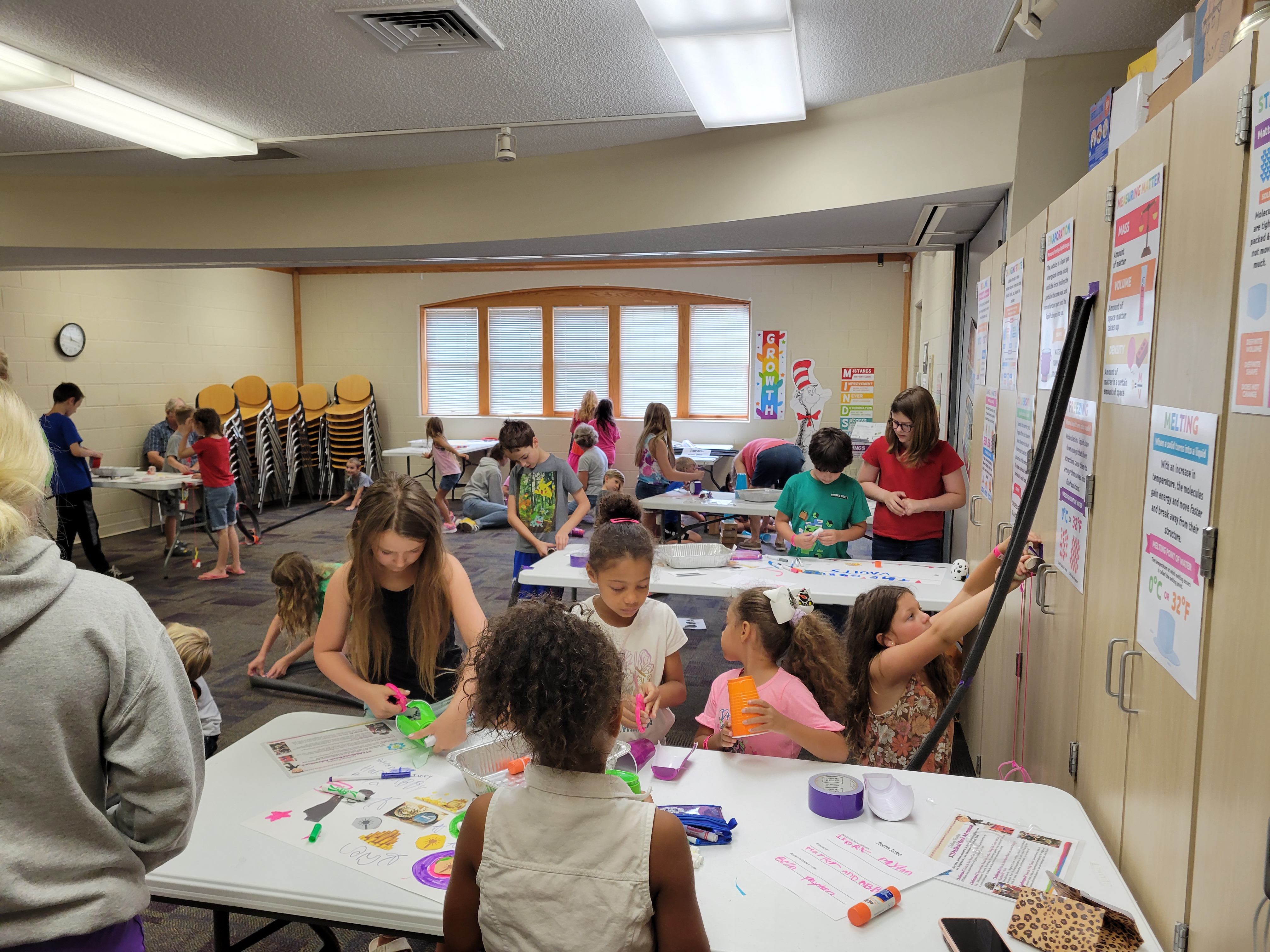 children working on building a roller coaster