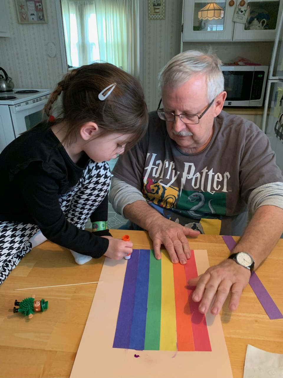 a child and her grandfather building a leprechaun trap
