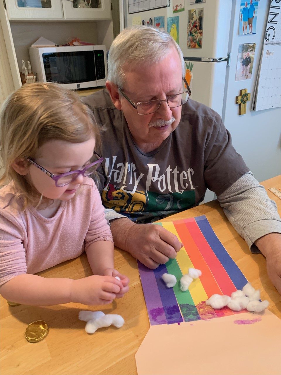 a child and her grandfather building a leprechaun trap