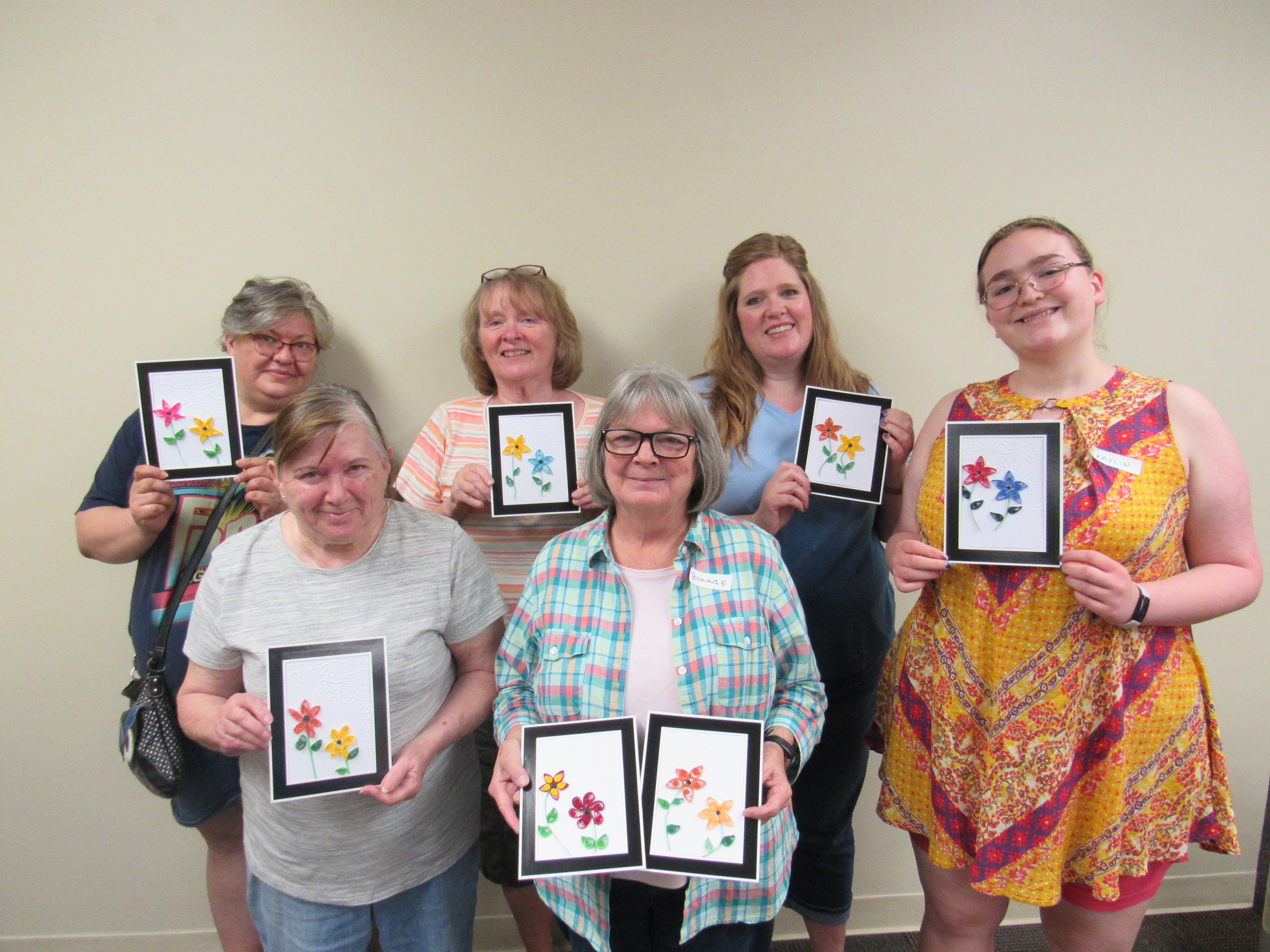 Participants show off their quilling craft