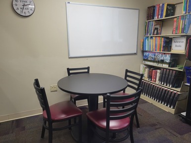 quiet study room with small table, chairs and white board